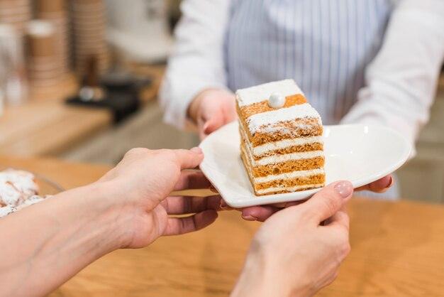 waitress-serving-pastry-white-plate-customer_23-2148028033